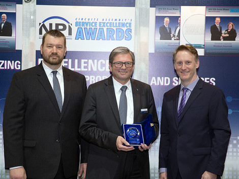 Ersa Sales Director Rainer Krauss (middle) and Ersa Sales Manager Todd DeZwarte with one of the two NPI Awards